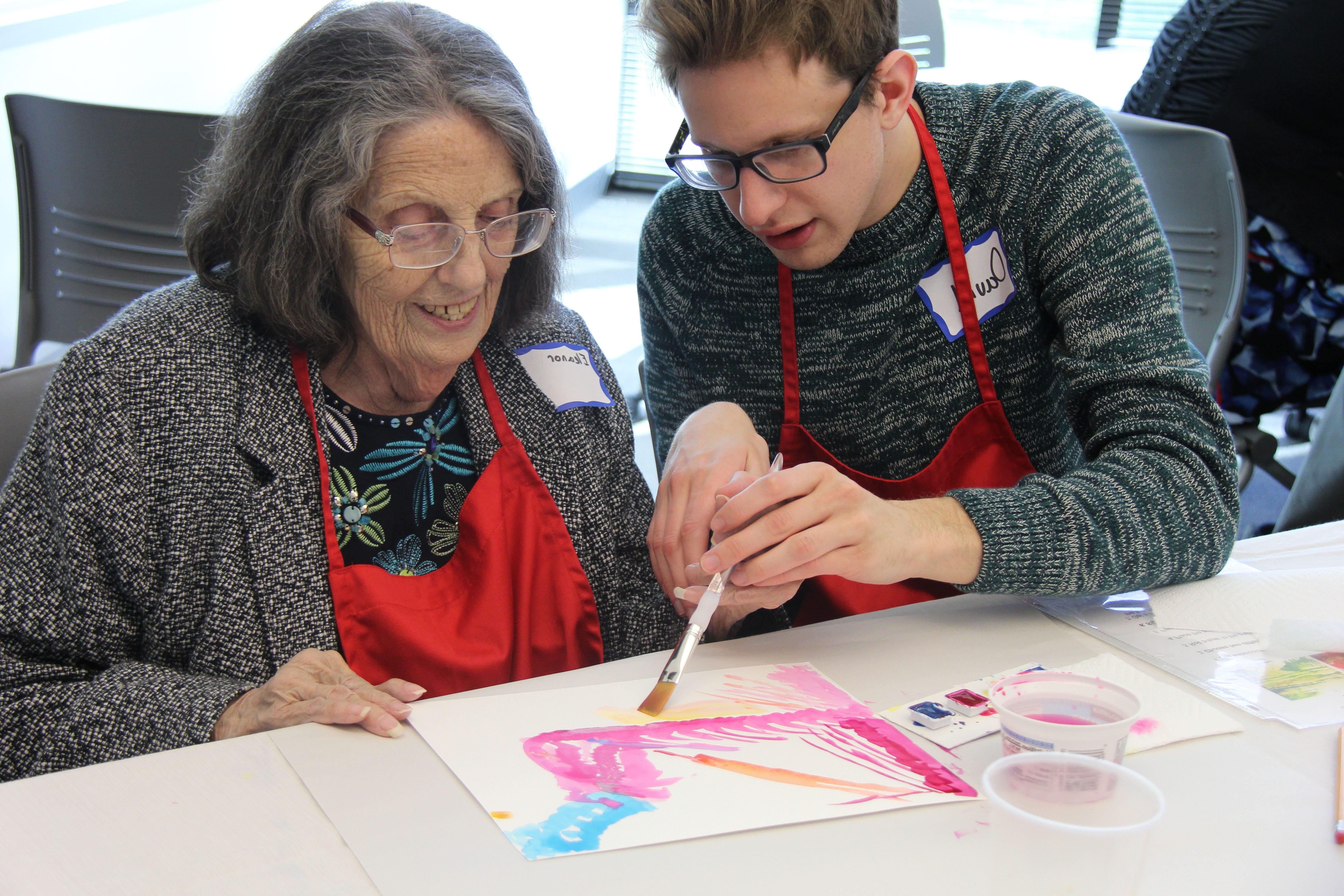 occupational therapy student helping patient with an art project